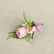 This artisan boutonniere, carefully arranged by Kenton's skilled florists and presented atop a natural, soft beige linen, radiates gentle elegance and upbeat charm. The central pastel pink rose, with elegantly furled petals, exudes a sense of fresh romance and optimism. A complementary, lighter peach or pink blossom-likely Alstroemeria-nestles nearby, displaying golden-yellow highlights and dainty speckles for extra dimension. Framing the main florals are airy clusters of delicate, white baby's breath and lively green miniature mums, infusing the piece with both softness and contemporary spirit. Lush foliage-slender, grass-like sprigs and smoothly folded, dark green leaves-forms a rich backdrop, echoing the greenery found around Preston Park. At the base, a striking fuchsia satin ribbon is tied in a neat and joyful bow, anchoring the stems and adding a sense of celebration. This carefully finished design catches the soft diurnal light, highlighting its layered hues and textures, and is perfect for Kenton weddings, prom nights, or any cherished local gathering-a floral accessory crafted with genuine care and an eye for memorable detail.